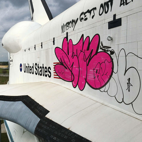 Abandoned space shuttle with professional throw-up graffiti tag showcasing SirCharles.DESIGN's Urban Graffiti product line for digital artists and street art designers