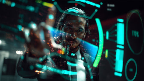 Mission control operator with cinematic holographic interface overlays and particle effects, demonstrating SirCharles.DESIGN's SciFi-inspired visual language designed for low-light aerospace environments in the award-winning HIVE system